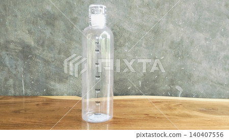 Clear Plastic Water Bottle with Time Marker on Wooden Table Clear Plastic Water Bottle with Time Marker on Wooden Table 140407556