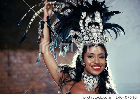 Portrait, samba dancer and black woman with headdress for carnival, festival or parade on urban background in Rio de Janeiro. Brazilian performer, female person and closeup in costume for performance Portrait, samba dancer and black woman with headdress for carnival, festival or parade on urban background in Rio de Janeiro. Brazilian performer, female person and closeup in costume for performance 140407586