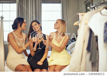 Friends, hotel and women with champagne for cheers with celebration, party and luxury in home. Happy, toast and group of female people talking with wine glasses and alcohol in bedroom at apartment. 140408013