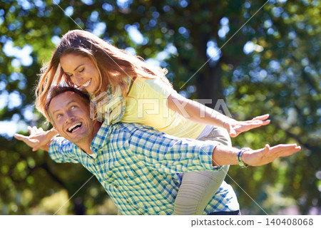 Smile, piggy back and couple in park for summer romance, trees and playful outdoor date. Love, mature man and happy woman in garden with morning sunshine, games and marriage bonding in nature. Smile, piggy back and couple in park for summer romance, trees and playful outdoor date. Love, mature man and happy woman in garden with morning sunshine, games and marriage bonding in nature. 140408068