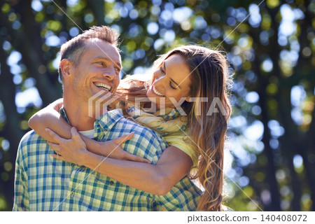 Piggy back, smile and couple in park for summer romance, trees and fun outdoor date with embrace. Love, mature man and happy woman in garden with morning sunshine, hug and marriage bonding in nature. Piggy back, smile and couple in park for summer romance, trees and fun outdoor date with embrace. Love, mature man and happy woman in garden with morning sunshine, hug and marriage bonding in nature. 140408072