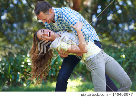 Love, smile and playful couple in park for summer fun and outdoor date together in nature. Romance, mature man and happy woman in garden with morning sunshine, playing and marriage bonding in trees. Love, smile and playful couple in park for summer fun and outdoor date together in nature. Romance, mature man and happy woman in garden with morning sunshine, playing and marriage bonding in trees. 140408077