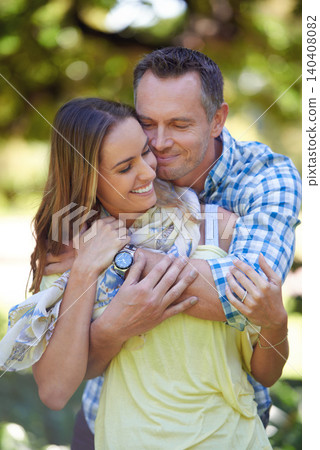 Nature, summer and couple with hug in park for bonding, marriage and anniversary in countryside. Forest, man and woman with happiness for commitment on date, holiday and vacation together for love 140408082