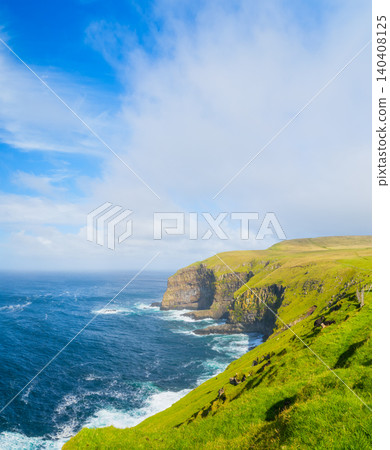 Scenic summer landscape of Faroe Islands with green fields, meadows and rocky cliffs by the ocean. Scenic summer landscape of Faroe Islands with green fields, meadows and rocky cliffs by the ocean. 140408125