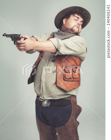Cowboy, man and shooting gun in studio, weapon and pistol with western costume isolated on white background. Plus size, criminal or funny person with revolver, guess aim or scared with fear in Texas Cowboy, man and shooting gun in studio, weapon and pistol with western costume isolated on white background. Plus size, criminal or funny person with revolver, guess aim or scared with fear in Texas 140408141