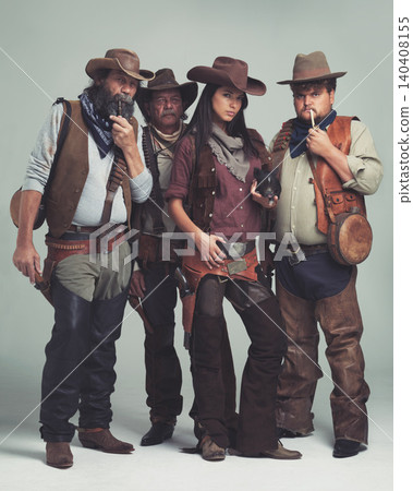 Vintage, fashion and portrait of cowboy in studio with clothes for halloween, character and costume. Man, woman and group of people with confidence for western, band and criminal lifestyle together Vintage, fashion and portrait of cowboy in studio with clothes for halloween, character and costume. Man, woman and group of people with confidence for western, band and criminal lifestyle together 140408155