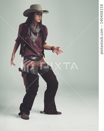 Woman, fashion and cowboy clothes with confidence in studio, western character and costume on white background. Wild west style, outlaw cosplay and vintage apparel with mockup space and aesthetic Woman, fashion and cowboy clothes with confidence in studio, western character and costume on white background. Wild west style, outlaw cosplay and vintage apparel with mockup space and aesthetic 140408158