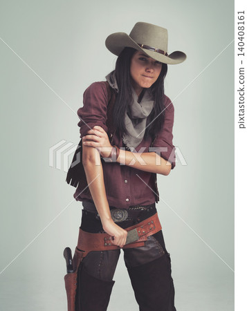 Western woman, cowgirl and strong in portrait, muscle and costume for tough with confidence. Female person, cowboy hat and clothes from Texas, white background and dress up for strength or proud Western woman, cowgirl and strong in portrait, muscle and costume for tough with confidence. Female person, cowboy hat and clothes from Texas, white background and dress up for strength or proud 140408161