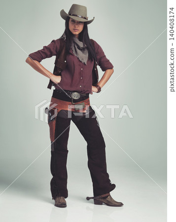 Woman, fashion and cowboy clothes with portrait in studio, western character and costume on white background. Wild west style, outlaw cosplay and vintage apparel with confidence and aesthetic Woman, fashion and cowboy clothes with portrait in studio, western character and costume on white background. Wild west style, outlaw cosplay and vintage apparel with confidence and aesthetic 140408174