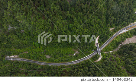 Spectacular drone overview reveals high mountain ridges along border of Austria and Slovenia. Massive Alpine peaks, deep valleys, and evergreen forests dominate majestic European landscape. Spectacular drone overview reveals high mountain ridges along border of Austria and Slovenia. Massive Alpine peaks, deep valleys, and evergreen forests dominate majestic European landscape. 140408342