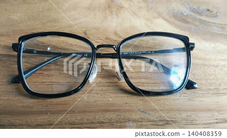 Black Frame Eyeglasses on Wooden Table Close Up Black Frame Eyeglasses on Wooden Table Close Up 140408359