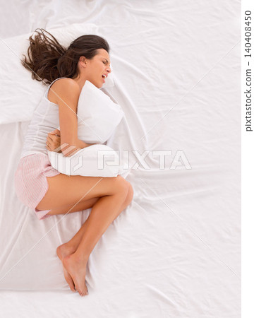 Woman, stomachache and pain on bed, cramps and appendicitis in home for discomfort. Female person, top view and constipation or ulcer in bedroom, muscle strain and bloating or menstrual crisis Woman, stomachache and pain on bed, cramps and appendicitis in home for discomfort. Female person, top view and constipation or ulcer in bedroom, muscle strain and bloating or menstrual crisis 140408450