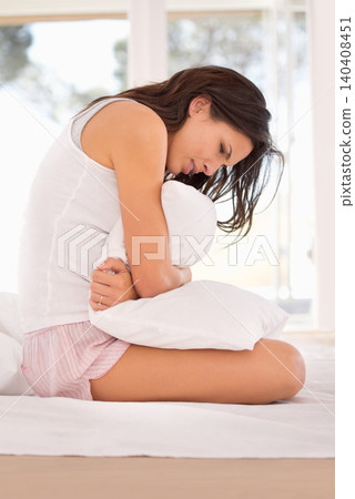 Woman, stomachache and period pain on bed, cramps and appendicitis in home for discomfort. Female person, pillow and constipation or ulcer in bedroom, muscle strain and bloating or menstrual crisis Woman, stomachache and period pain on bed, cramps and appendicitis in home for discomfort. Female person, pillow and constipation or ulcer in bedroom, muscle strain and bloating or menstrual crisis 140408451