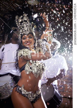 Carnival, woman and dancing in street with confetti and performance in Brazil, costume and feather head gear outdoor. Music, samba and happy for event, culture with festival entertainment and talent 140408514