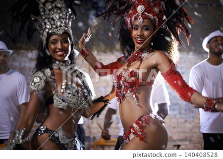 Samba, portrait and performance of women in Rio de Janeiro, smile and dancing for crowd with energy. Female people, artistic and clothes from feather for fashion with culture, music and celebration 140408528