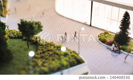 Architectural model showing cityscape, green spaces, and tiny people on a sunny day Architectural model showing cityscape, green spaces, and tiny people on a sunny day 140408530