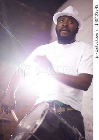 Drummer, playing and music with percussion drums on stage, rhythm and black man with talent in band. African person, beat and performing in group as professional musician and lighting for live show Drummer, playing and music with percussion drums on stage, rhythm and black man with talent in band. African person, beat and performing in group as professional musician and lighting for live show 140408548