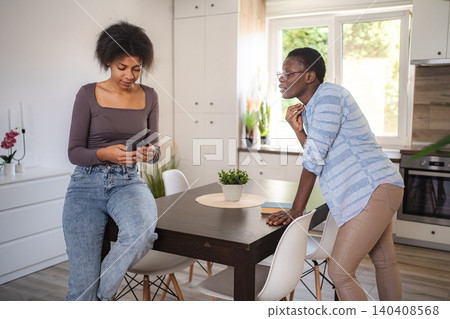 Mother scolding her daughter for using phone too much at home Mother scolding her daughter for using phone too much at home 140408568
