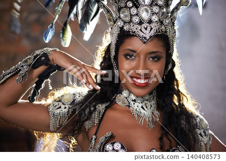 Happy woman, portrait and samba dancer with costume for performance at carnival or festival. Face of female person or exotic performer with smile and cultural fashion for dancing or concert in Rio 140408573