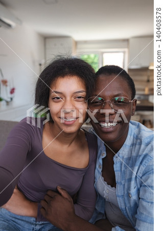 Two Young Women Embracing on the Sofa at Home Two Young Women Embracing on the Sofa at Home 140408578