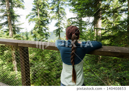 Child enjoying forest view on canopy walkway Child enjoying forest view on canopy walkway 140408653