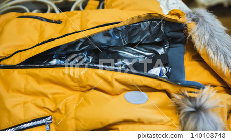 Yellow winter jacket with fur hood and thermal lining, ready for cold weather 140408748