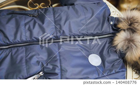 Quilted winter jacket featuring blue fabric, zipper, and faux fur hood Quilted winter jacket featuring blue fabric, zipper, and faux fur hood 140408776