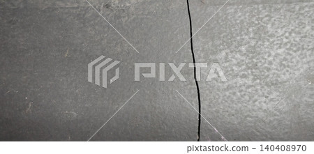 Dark colored concrete or cement surface with prominent vertical cracks. Dark colored concrete or cement surface with prominent vertical cracks. 140408970
