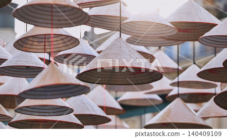 Traditional Vietnamese conical hats hanging in Hoi An, Vietnam Traditional Vietnamese conical hats hanging in Hoi An, Vietnam 140409109