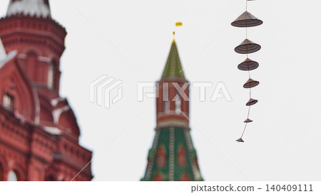 Asian conical hats hanging as street decoration with blurred historic red brick towers. Asian conical hats hanging as street decoration with blurred historic red brick towers. 140409111