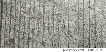 The surface of the sidewalk or concrete floor has a texture in the form of a repeating vertical line pattern. The surface of the sidewalk or concrete floor has a texture in the form of a repeating vertical line pattern. 140409193
