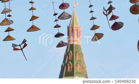 Vietnamese conical hats hanging with Moscow Kremlin tower in background Vietnamese conical hats hanging with Moscow Kremlin tower in background 140409230