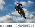 A motorcyclist jumping 140409314