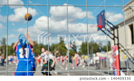 Basketball Game Captured Through Wire Fence on Sports Day 140409330