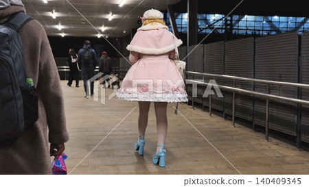 Young woman walking in lolita fashion on urban walkway at night 140409345