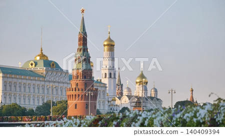 Moscow Kremlin architecture and golden domes rising above flowering plants 140409394