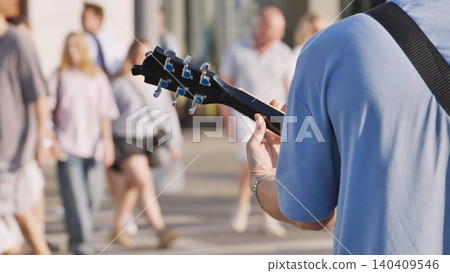 Street musician playing guitar for loving in city Moscow street Street musician playing guitar for loving in city Moscow street 140409546
