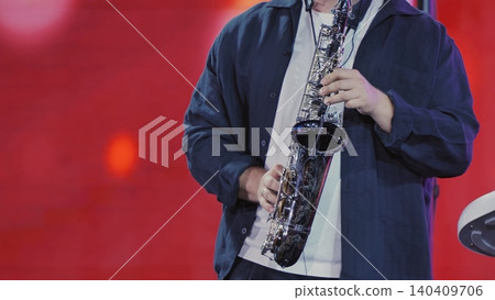 Musician playing an alto saxophone during a live jazz or blues music concert Musician playing an alto saxophone during a live jazz or blues music concert 140409706