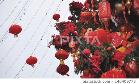 Chinese New Year decorations featuring hanging red lanterns and festive ornaments Chinese New Year decorations featuring hanging red lanterns and festive ornaments 140409778