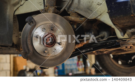 Car suspension system and disc brake rotor during maintenance in Moscow garage Car suspension system and disc brake rotor during maintenance in Moscow garage 140409843