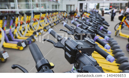 Moscow street full of yellow and purple electric scooters ready for urban sharing Moscow street full of yellow and purple electric scooters ready for urban sharing 140409853