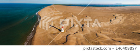 Aerial view of Fangar Lighthouse surrounded by coastal sand dunes and Mediterranean shoreline in the Ebro Delta Aerial view of Fangar Lighthouse surrounded by coastal sand dunes and Mediterranean shoreline in the Ebro Delta 140409857