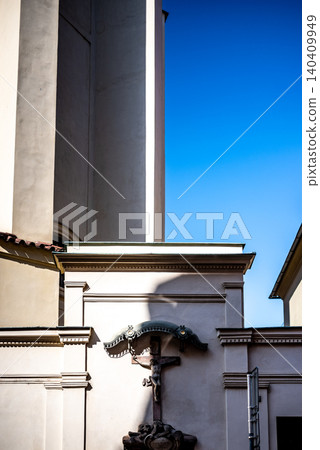 Church wall with crucifix under blue sky Church wall with crucifix under blue sky 140409949
