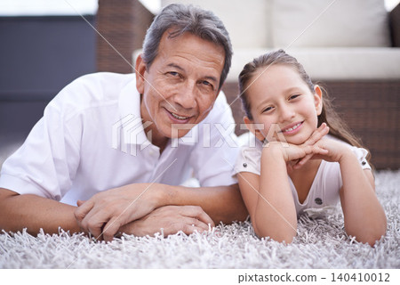 Happy, portrait and grandpa with girl in home on holiday or vacation together in retirement with smile. Senior, man and grandparent relax with child on floor in living room and bonding in Mexico Happy, portrait and grandpa with girl in home on holiday or vacation together in retirement with smile. Senior, man and grandparent relax with child on floor in living room and bonding in Mexico 140410012