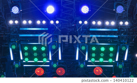 Concert stage lighting equipment creating colorful blue, green, and red illumination at event Concert stage lighting equipment creating colorful blue, green, and red illumination at event 140410122