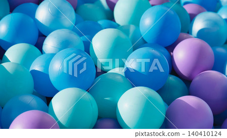Plastic ball pit creating a vibrant background for children's play and fun Plastic ball pit creating a vibrant background for children's play and fun 140410124