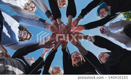 Students uniting in a circle to symbolize unity and teamwork on a sunny school day Students uniting in a circle to symbolize unity and teamwork on a sunny school day 140410183