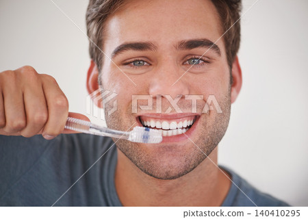 Face, man brushing teeth and toothbrush for dental and wellness, fresh breathe and tooth whitening in morning routine. Clean mouth, toothpaste and oral care with orthodontics and hygiene in portrait Face, man brushing teeth and toothbrush for dental and wellness, fresh breathe and tooth whitening in morning routine. Clean mouth, toothpaste and oral care with orthodontics and hygiene in portrait 140410295
