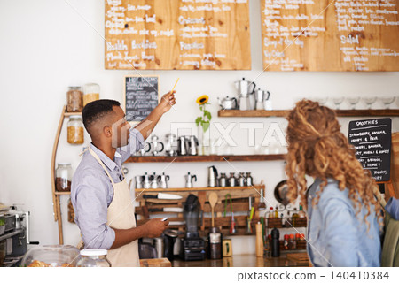 Coffee shop, customer and barista with pointing at menu for purchase, decision and service at restaurant. Waiter, small business and woman at cafe with options, discussion and choice for lunch order Coffee shop, customer and barista with pointing at menu for purchase, decision and service at restaurant. Waiter, small business and woman at cafe with options, discussion and choice for lunch order 140410384