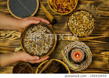 Cultural holiday food concept representing Ukrainian Christmas culinary tradition. Traditional Ukrainian Christmas kutya with ingredients and candle. Cultural holiday food concept representing Ukrainian Christmas culinary tradition. Traditional Ukrainian Christmas kutya with ingredients and candle. 140410459